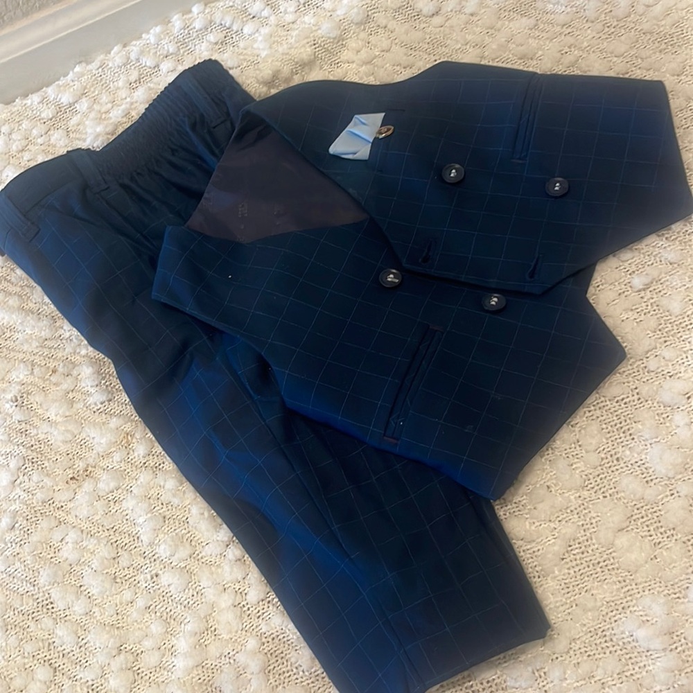 Navy blue vest and pants for walker in baby boy.